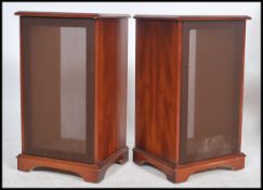 A pair of contemporary mahogany cased speaker hi-fi covers. Each with fabric facia and having plinth