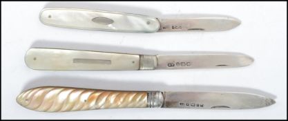 A group of silver hallmarked and mother of pearl fruit knives to include a Victorian example with
