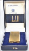 A vintage 20th century Dunhill model no 70 gas lighter of rounded oblong form with gold plated