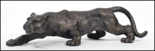 A large cast iron figure of a jaguar / wild cat having detailed face and jaw painted in a bronze