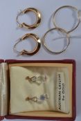 Two pairs of 9ct gold hoop earrings. Total Weight 1.5g. Unmarked test 9ct gold. Together with a pair