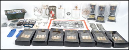 A collection of vintage collectable Guinness advertising items to include boxed darts, bottle