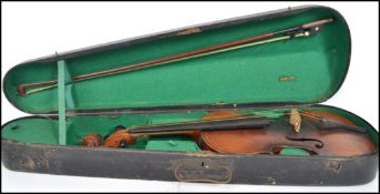 A 19th Century violin bears label Peter Guarnerius, with bow with mother of pearl inlay, contained