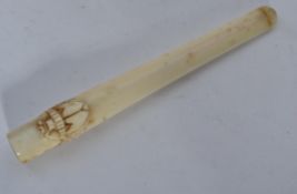 A 19th century ivory cheroot of tapering form with carved winged beetle scarab to top.