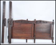 A late 19th / early 20th century French walnut  bed having carved scrolling detail and united by the