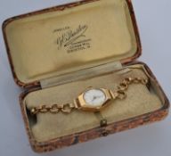 A 9ct gold ladies dress / cocktail watch complete in the box set to a 9ct loop link bracelet