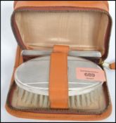A silver hallmarked cased vanity set consisting of brush and comb having engine tuned decoration,