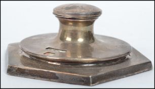 A silver hallmarked ink well desk calendar, set on an octagonal base surmounted with a hinged