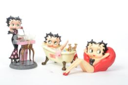 A vintage Betty Boop figurine featuring the iconic character in a bath tub along with  a vintage