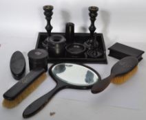 A vintage early 20th century ebonised ladies dressing table set to include brushes, hand mirror,