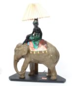 An early 20th century plaster / Chalk ware fairground prize table lamp in the form of an elephant