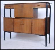 A mid 20th century retro / vintage tall sideboard cocktail cabinet, the sideboard raised on an
