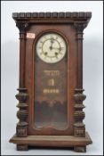 A 19th century walnut Vienna wall clock having white enamel dial with roman numerals having an 8 day