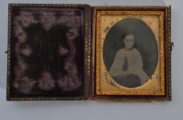 A 19th century Victorian ambrotype of a girl set in an ornate gilt frame housed within the