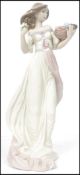A Lladro ceramic figurine of a lady holding a basket of fruit and flowers entitled Autumn Romance