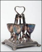 A vintage 20th century four person silver plated egg cruet set consisting of four egg cups and