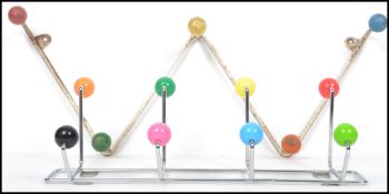 A set of mid century vintage Sputnik atomic coat hooks of wave form with painted ball ends along