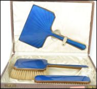 A vintage 20th century cased silver hallmarked and enamel engine turned back vanity set comprising