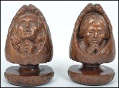 A pair of unusual carved wooden bookends in the form of winged angels in prayers raised on