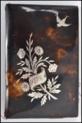 A vintage 19th century tortoise shell purse having a silver inlaid decoration of flowers and bird.