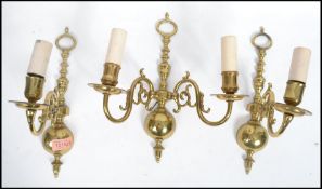 A set of three cast brass early 20th century scrolled wall sconces in the 17th century Dutch