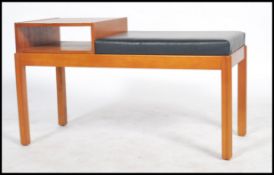 A retro mid century teak wood telephone table in the manner of Mr Chippy. Raised on squared shaped