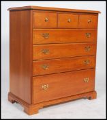 A  20th century straight chest of five drawers, each drawer fitted with drop swag handles, batwing