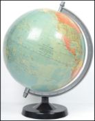 A retro 20th century vintage 1978 political desk top globe being raised on an ebonised plinth base.