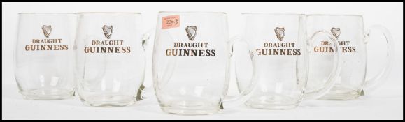A collection of five, vintage collectable / promotional Guinness 3 pint tankards / mugs, four