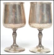 A pair of silver hallmarked christening / wine goblets by Cooper Bros & Sons Sheffield date letter E