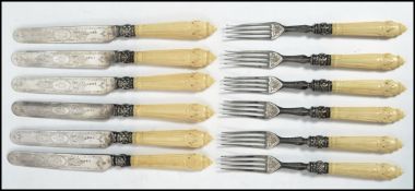 A set of six 19th century ivory handled knives and forks having silver collars having Dieppe