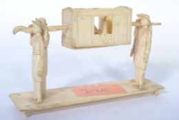 A 19th century Indian Raj period bone and ivory model of a nobleman in litter being carried by