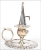 A Victorian silver chamber stick, London 1890, circular form, scroll border, spool shaped capital,