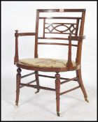 A late 19th century / early 20th century bedroom armchair raised on turned and splayed legs united