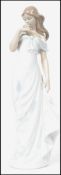 A Lladro ceramic figurine entitled ' A Flowers Whisper ' depicting a lady in a dress holding a