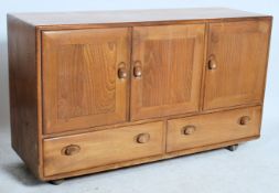 A retro Ercol 20th century windsor pattern golden dawn elm sideboard having a series of drawers over