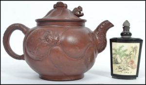 An Oriental Yi Xing terracotta teapot having a metamorphic dragon to body with moving head and