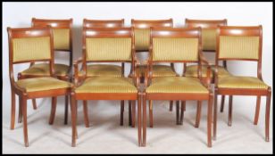 A set of 8 Regency revival mahogany dining chairs raised on sabre supports with velour drop in seats