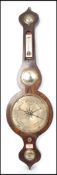A 19th century Georgian banjo barometer having silvered dial with thermometer having mercury back