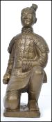 A large gilded plaster Chinese figurine of a terra
