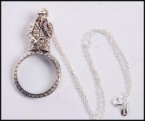 A sterling silver magnifying glass in the form of