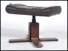 A 1970 Kebe leather footstool / ottoman on a woode