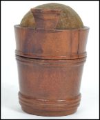 A 19th century treen pin cushion in the form of a