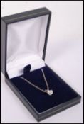 A 14ct white gold circular cut diamond pendant nec