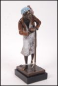 A cold painted bronze figurine of an Arab figure c