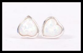 A air of sterling silver opal stud earrings of hea