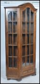 A 20th century upright oak vitrine display cabinet