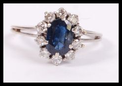 A white gold sapphire and diamond ring having a ce
