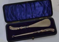 A silver hallmarked button hook and shoe horn set