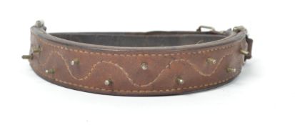 An early 20th century leather and metal studded do